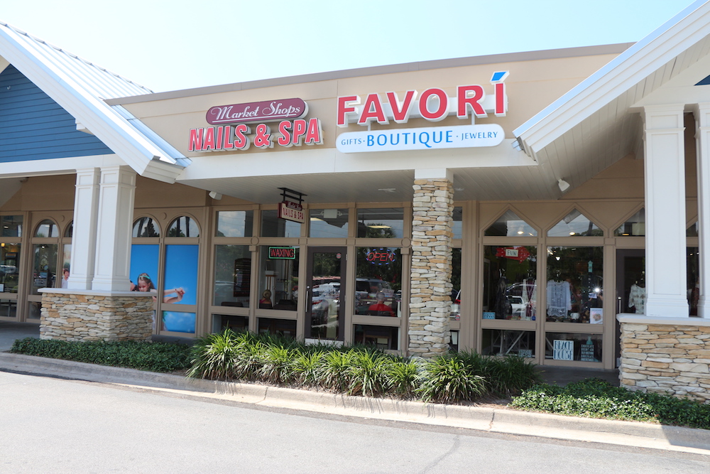 A storefront view of both Favori Boutique and Market Shops Nails and Spa at the Market Shops in Sandestin, Florida.