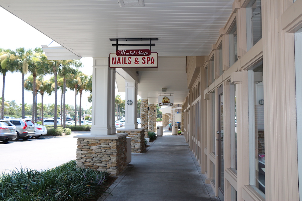 The Market Shops Nail and Spa wooden sign outside of the store at the Market Shops in Sandestin, Florida.