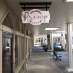 The outside of Primp Salon in Sandestin, Florida, which includes a wooden sign to indicate where the salon is.