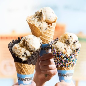 A waffle cone with chocolate around the top, a plain waffle cone, and a waffle cone with chocolate and sprinkles around the top all with ice cream in them from Ben and Jerry's in Sandestin, Florida.